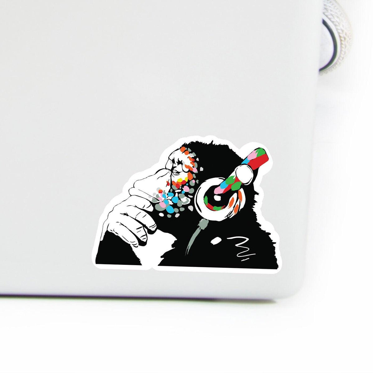 Glow in the dark monkey laptop vinyl sticker with colorful headphones for music lovers.