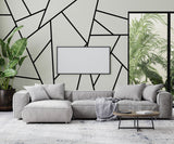 Modern living room featuring black mountain line wall decals, a cozy gray sofa, and lush indoor plants.