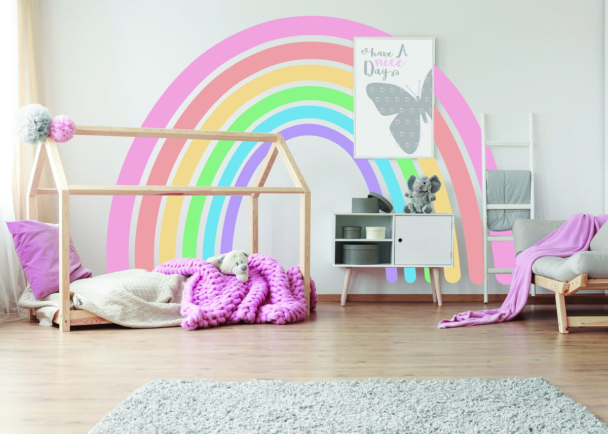 Pastel rainbow adhesive wall sticker in a cozy nursery, brightening up the space with playful colors.