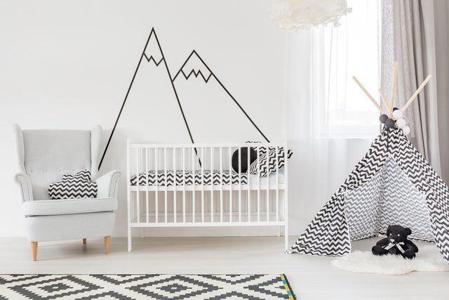 Stylish nursery featuring Black Mountain Line Peel and Stick decals above a white crib and patterned teepee.