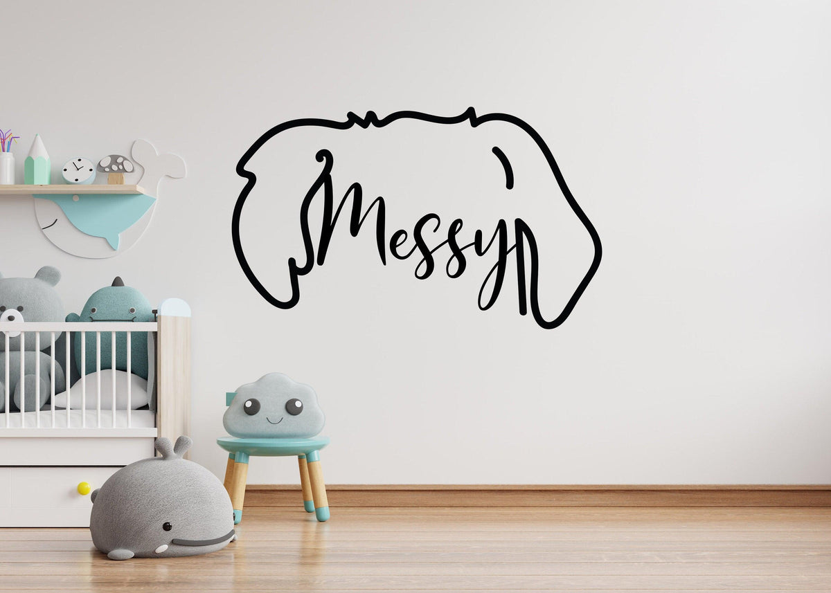 Vinyl wall decal of a dog's ears with the word 'Messy,'.