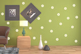 Elegant white daisy wall decals on green wall, creating a fresh and charming floral decor for any room.