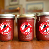 Three jars with red 'No Milk Allergy Alert' stickers for food safety and allergy awareness.