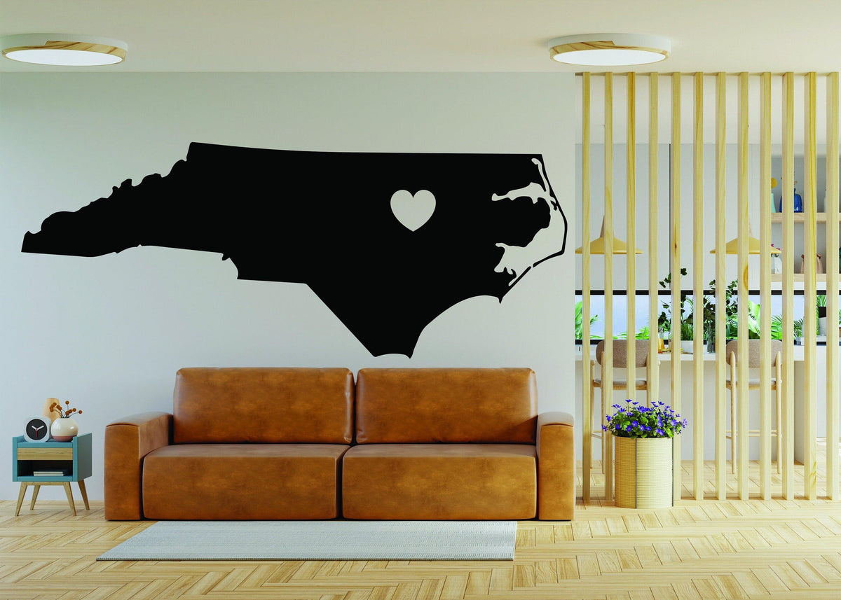 North Carolina wall decal featuring a heart symbol, showcased in a modern living room setting.