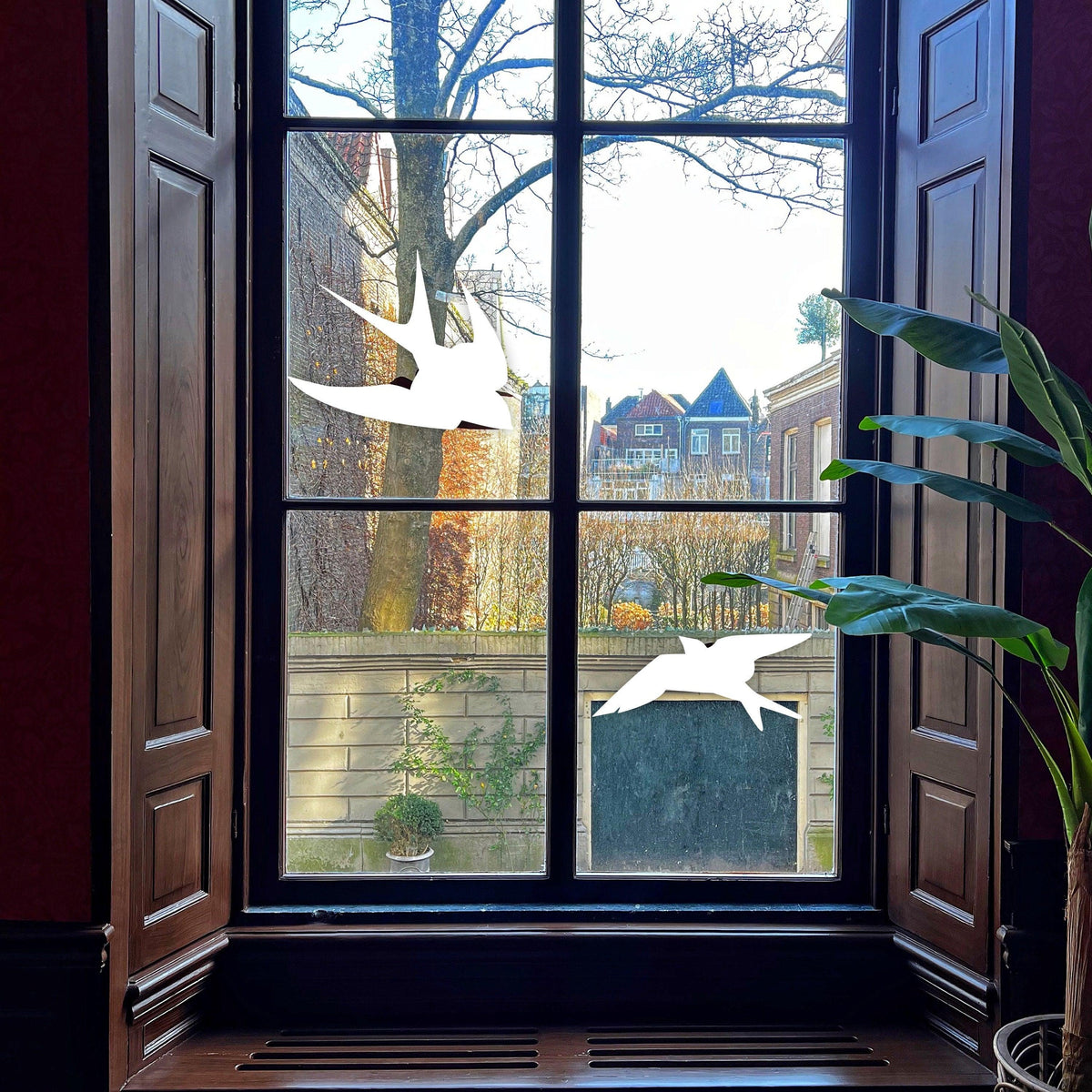 Window view featuring Anti-Collision Bird Decals to prevent bird strikes, with silhouettes of flying birds.