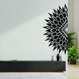 Half geometric mandala wall decal in black on a light wall, enhancing modern living room decor.