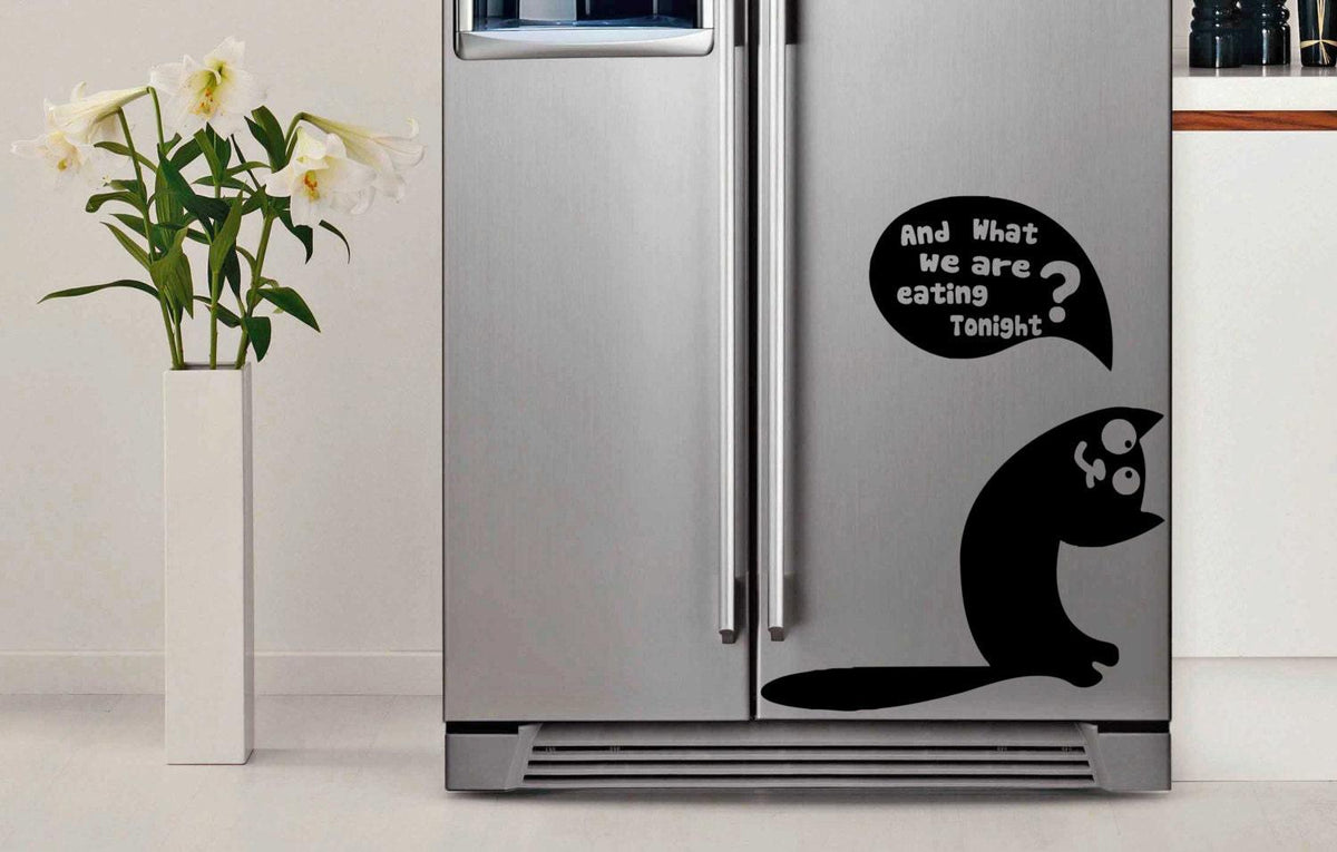 Funny cat vinyl sticker on a silver fridge with text asking, 'And what are we eating tonight?' for kitchen decor.