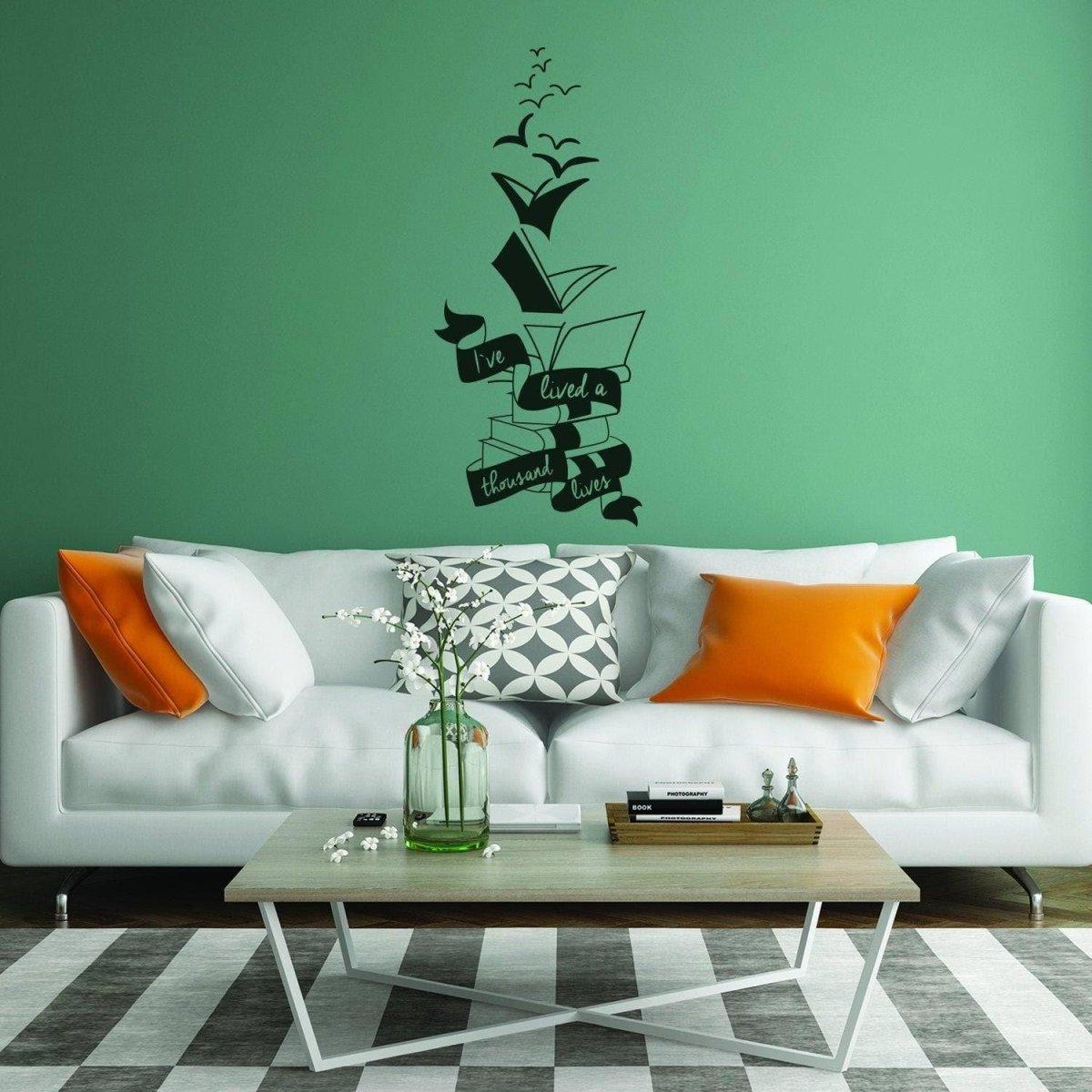InspireSpace motivational wall sticker on a green wall above a stylish sofa in a modern living room.