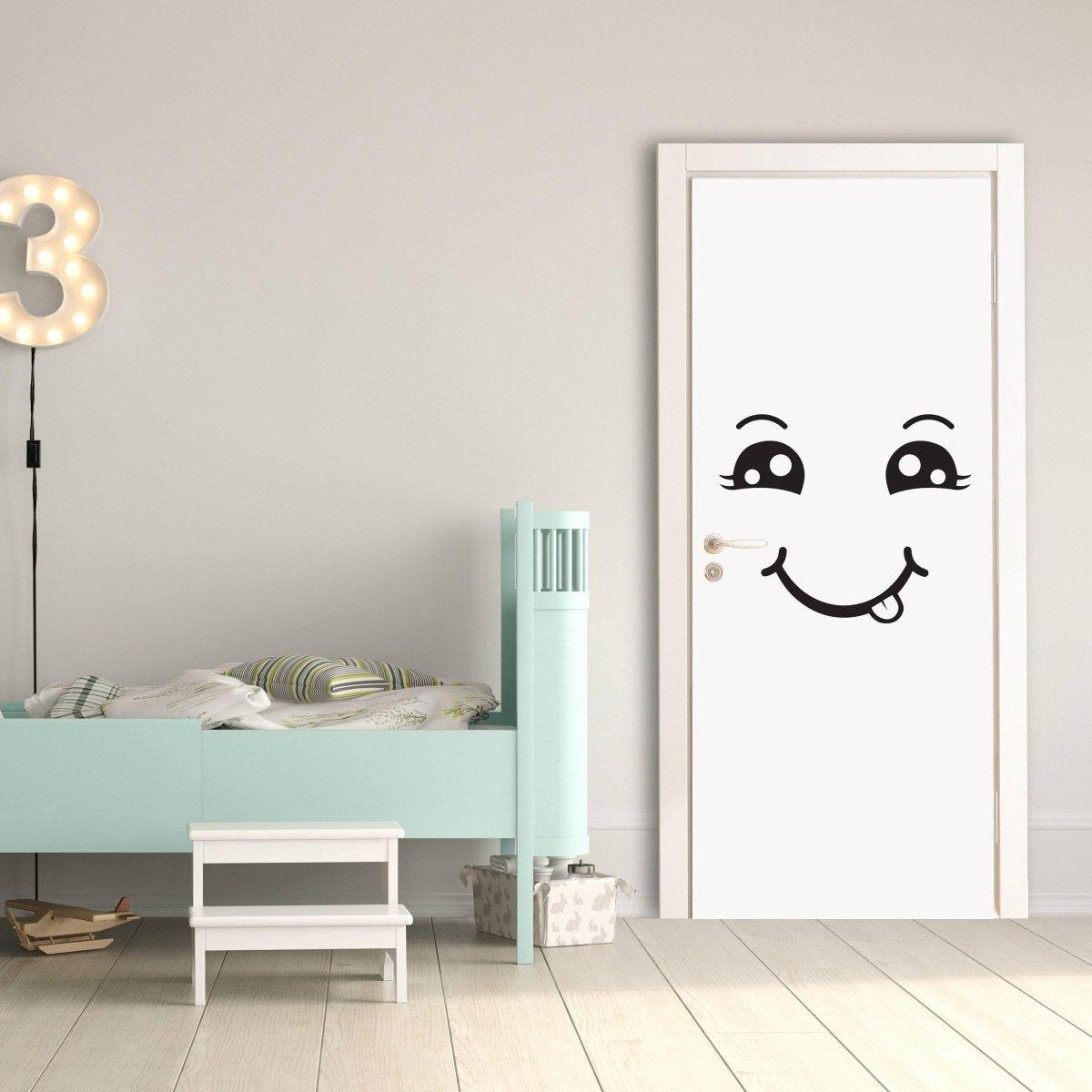 Smiley face wall decal on a white door in a cheerful children's bedroom with a blue bed.