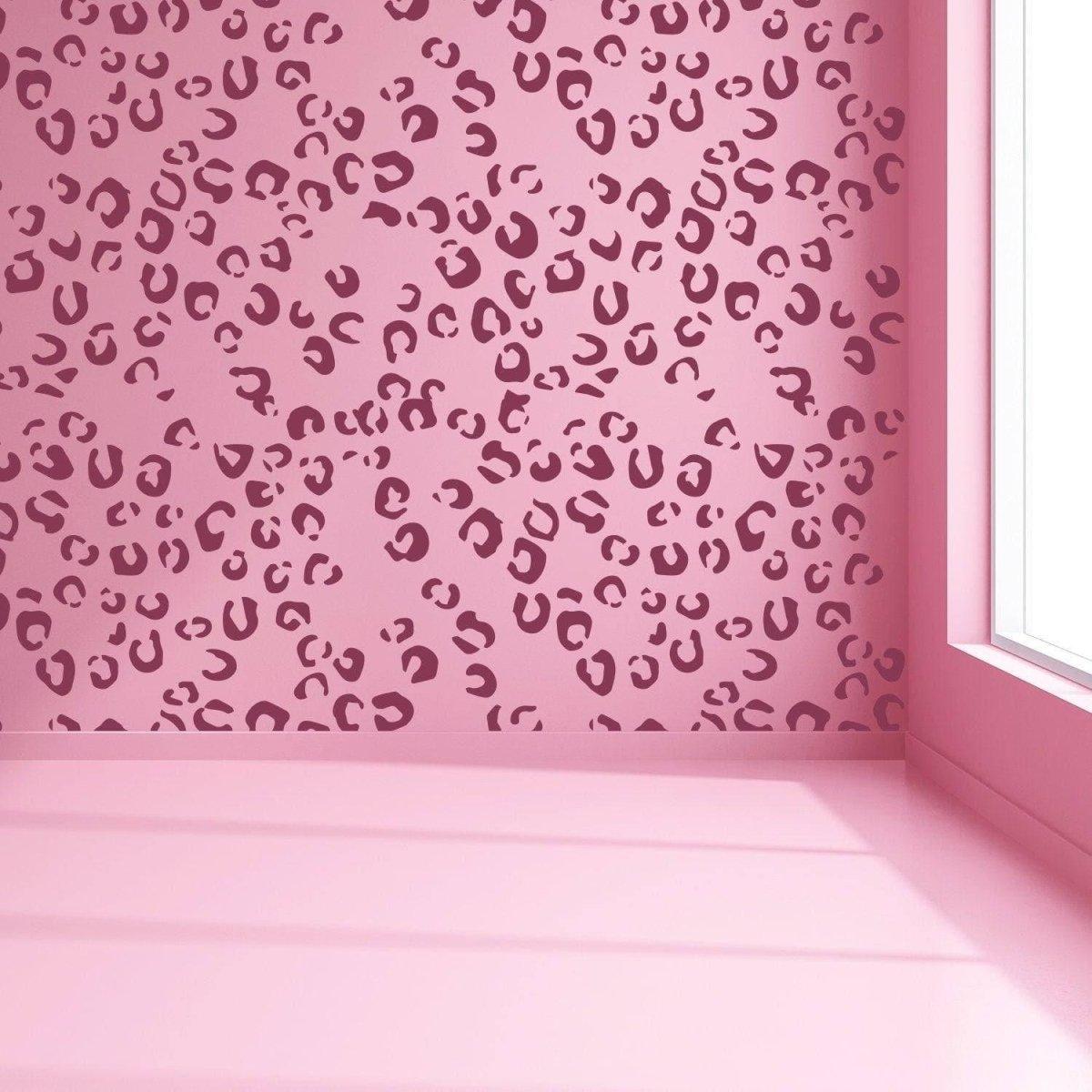 Leopard spot vinyl decals on a pink wall, creating a stylish and cute interior decor.