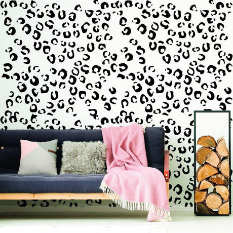 Leopard spot vinyl decals on a wall, enhancing a cozy living room with stylish decor and a pink throw blanket.