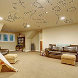 Constellation Luminary Decal Kit on ceiling in cozy living space, transforming decor with glow-in-the-dark star stickers.
