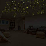 Glow-in-the-dark constellation decals illuminating a cozy room ceiling, creating a starry night sky effect.