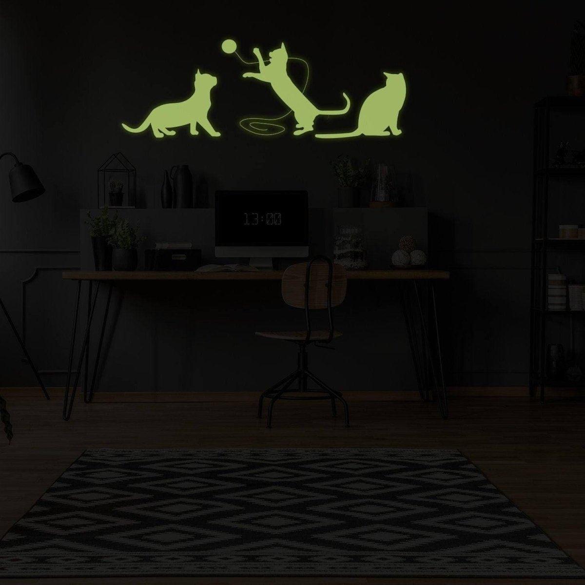 Glow in the dark feline wall decal featuring playful cats.