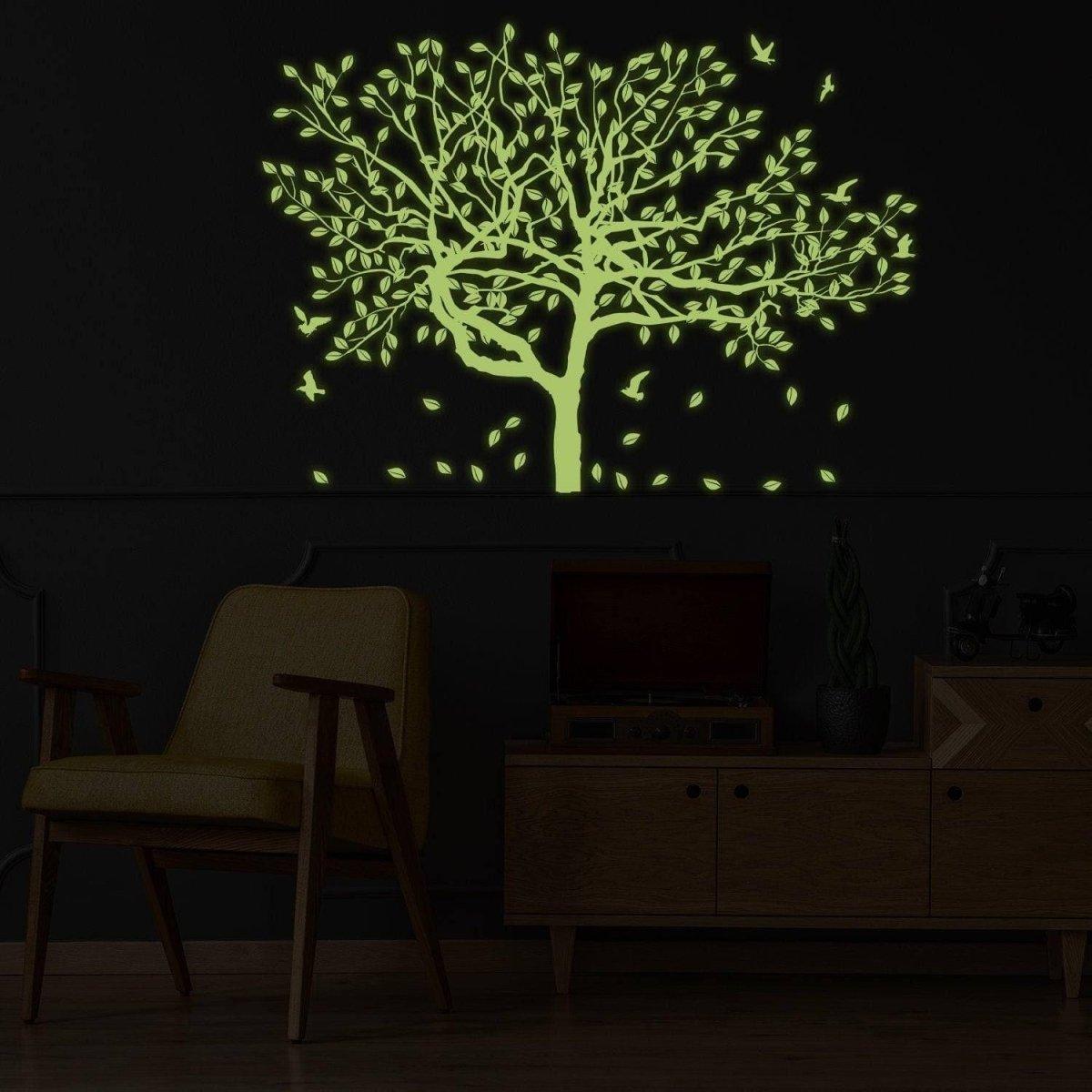 Glow-in-the-dark tree wall decal with luminous leaves and birds for kids' room decor.
