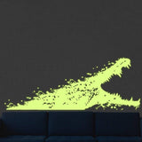 Glowing alligator wall decal on dark wall.