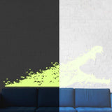 Glow-in-the-dark alligator wall decal displayed on a wall next to a blue sofa in a stylish kids' room.