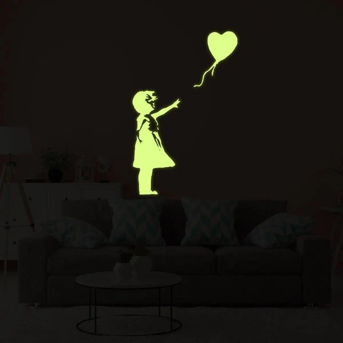 Glow in the dark vinyl sticker of a girl with a heart balloon.