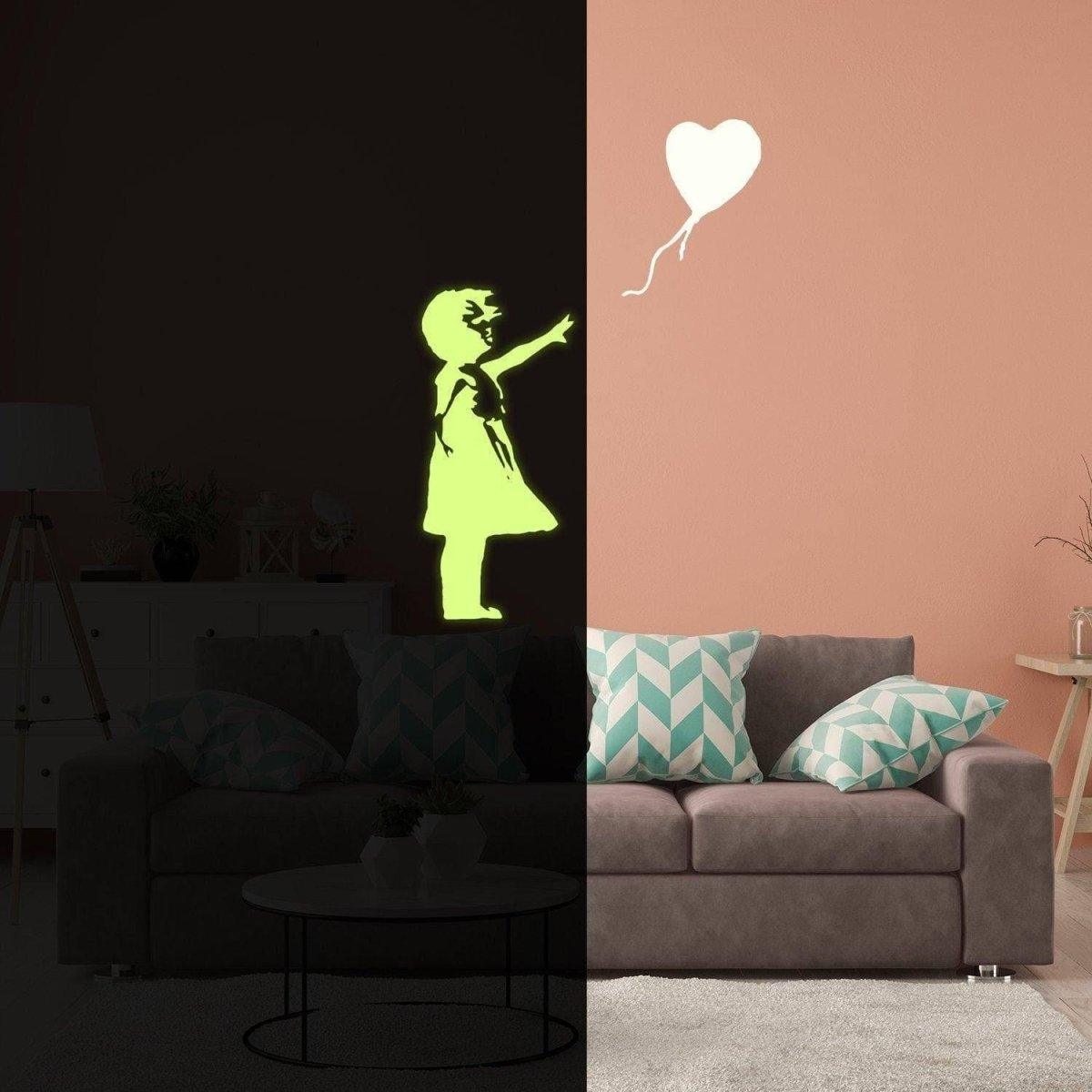 Luminescent girl silhouette with heart balloon wall decal glowing in a dark room over a cozy couch.