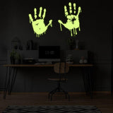 Glowing zombie blood wall decal featuring luminous bloody hands in a dark room.